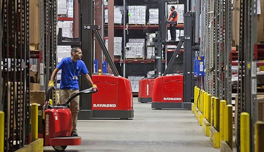 Photo of a warehouse with people working